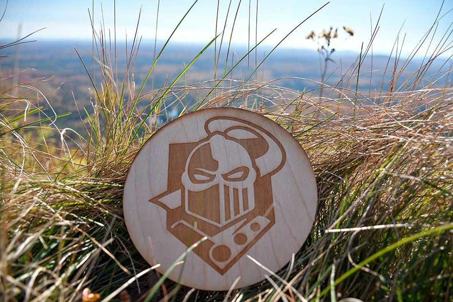 Coaster with Clarkson logo on it in the grass