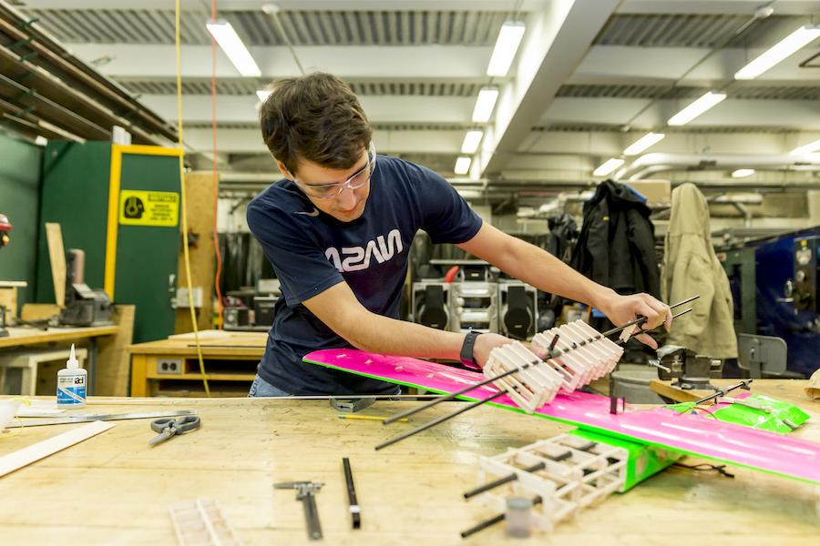 Design build fly project student working on model.